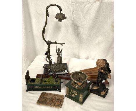 A gilt metal table lamp with girl on a swing; a Victorian style cast iron money box; a coffee grinder; etc. 