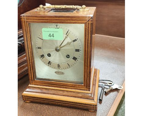 A 19th century French mantle clock in inlaid rosewood case with silvered dial and striking movement by Henri Marc 