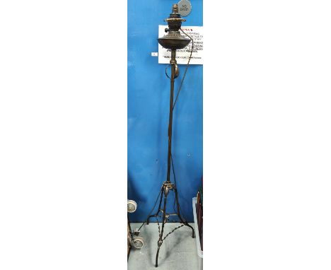 An Arts and Crafts/ Art Nouveau brass standard lamp with fringed shade 