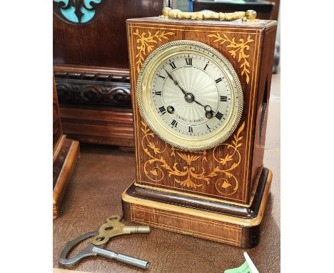 A 19th century French mantle clock in inlaid rosewood case with silvered dial and striking movement by Laine a Paris 