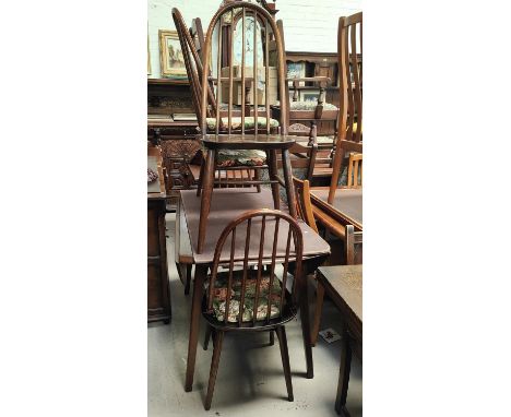 An Ercol dark oak dining suite comp. drop leaf table and 4 high hoop and stick back dining chairs 