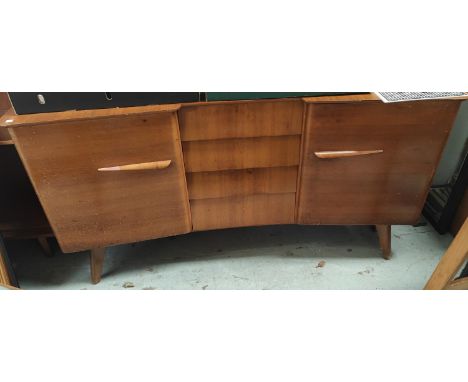 A mid 20th century light wood sideboard with angled and stepped front, four central drawers and two cupbaords 