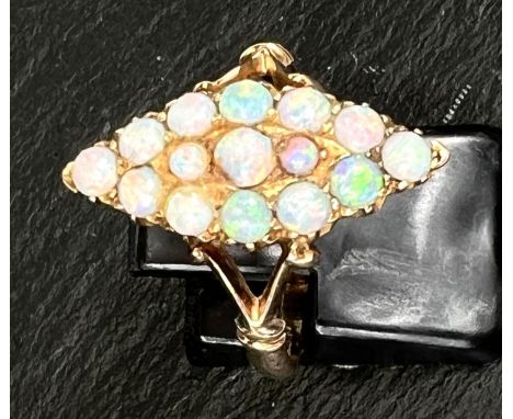 A marquise shaped dress ring set 15 opal beads in yellow gold shank, stamped '15ct' 