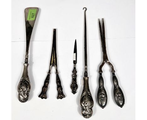 A hallmarked silver shoehorn and button hook set, cherub embossed, Birmingham 1903; a similar pair of curling tongs; glove st