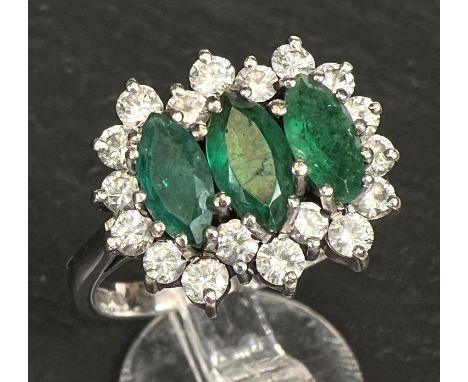 A ladies dress ring set 3 marquise cut emeralds surrounded by 18 diamonds in 18 carat white gold 