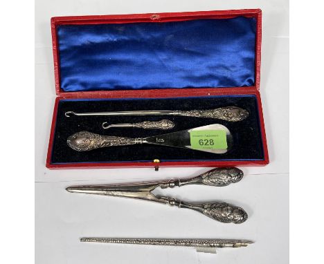 A cased 3 piece set of shoehorn, boot &amp; button hook with embossed handles; a similar pair of glove stretchers and dip pen
