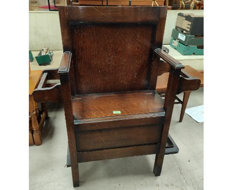 A 1930's oak hall seat with hinged lid, stick and umbrella stands 