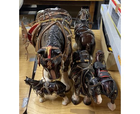 A very large ceramic shire horse, H. 45cm. Together with three others and a cart.