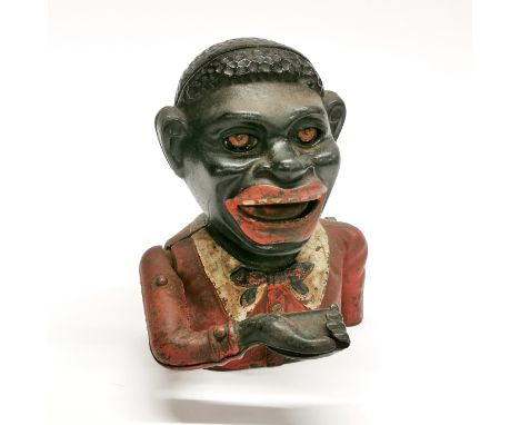 An old cast iron black boy money box, H. 16cm. Notice from the the-saleroom.com: These items are listed on the basis they are