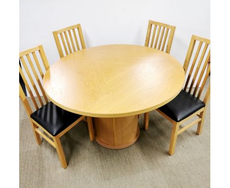 A light beech circular revolving dining table and four chairs, dia 118cm.