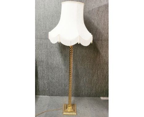 A brass spiral standard lamp and shade, H. 169cm.