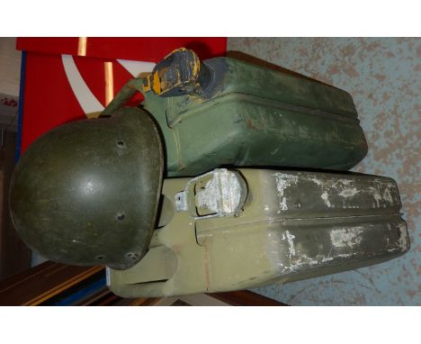 Two metal jerry cans and a military helmet