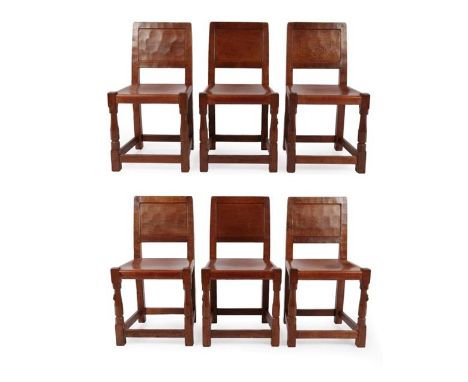 Robert Mouseman Thompson (1876-1955): A Set of Six English Oak Panel Back Dining Chairs, 1949, adzed frames, slung solid tan 