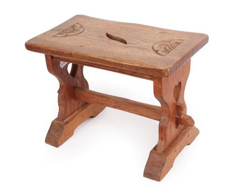 Yorkshire School: An English Oak Stool, the top with carved rose and leaf aperture, on two shaped supports each with pierced 