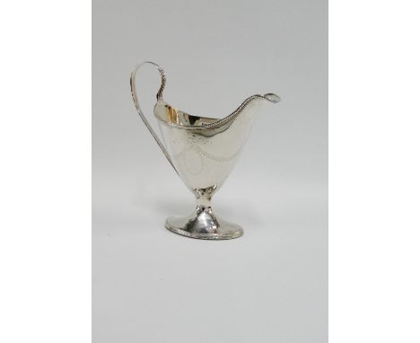 Georgian silver helmet shaped cream jug with bright cut garland swags and on an oval base, 16cm high 