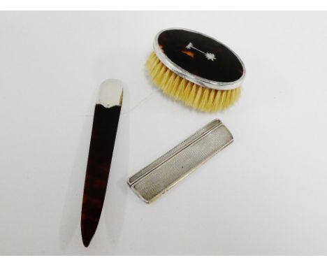 A collection of early 20th century silver and tortoiseshell to include a bookmark, comb and small clothes brush (3) 