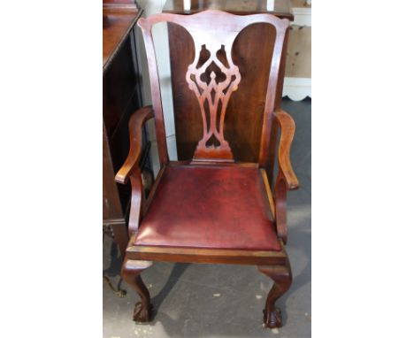 A set of seven 1920s Chippendale revival mahogany dining chairs with pierced splats on angular cabriole legs, with ball & cla