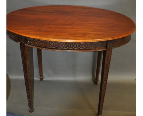 A Chippendale Revival mahogany table, the oval top above a blind fret frieze and square tapering legs, on splayed feet, W. 91