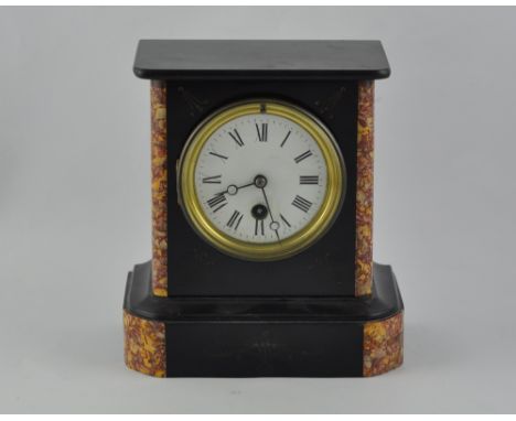A late 19th century black slate mantel time piece, the case with red marble insets, the white enamel dial set out in Roman nu