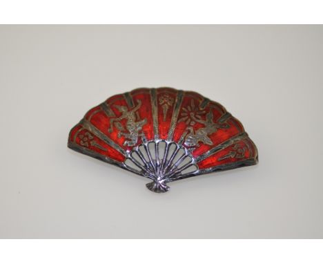 A Siamese white metal and red enamel brooch, shaped in the form of a fan and decorated with dancers, 9g.