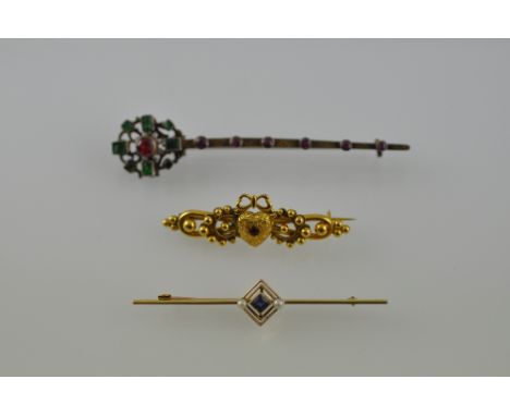 A yellow metal brooch in the form of a heart set set with a ruby flanked by balls; together with a sapphire and pearl bar bro