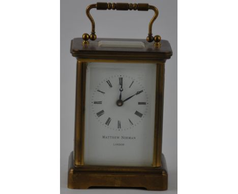 A 20th century carriage timepiece, the corniche case with bevelled panes and white enamel dial set out in Roman numerals with