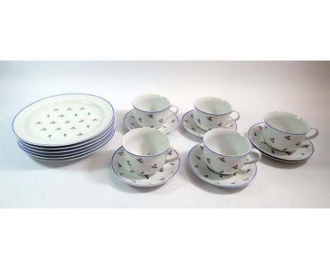 A Polish floral breakfast set comprising five cups and six saucers and six breakfast plates 