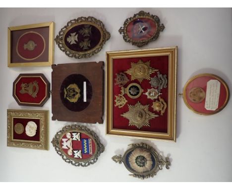 A box of various framed military badges, helmet plates and patches including Air Transport Auxiliary, 2nd Battalion Herts RV,