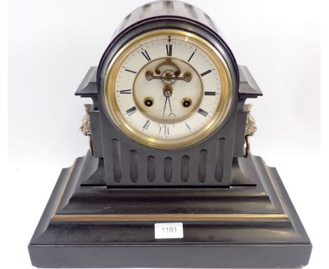 A Victorian black slate mantel clock with visible escapement and enamel dial with lion masks to sides, 39cm wide