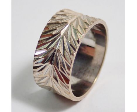 A 9 carat white gold textured ring, 8mm wide, size K, 4.5g