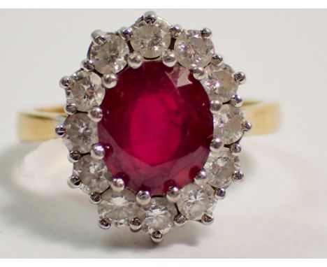 An 18 carat gold ruby and diamond cluster ring, size P, 5.8g, cluster 11mm x 9mm