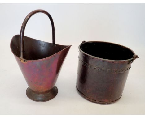 A brass studded coal bucket and a copper helmet form one 