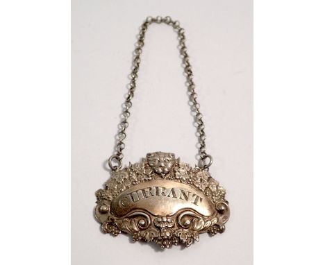 A silver 'CURRANT' bottle ticket or decanter label decorated lion mask and vines, London 1821, by George Knight