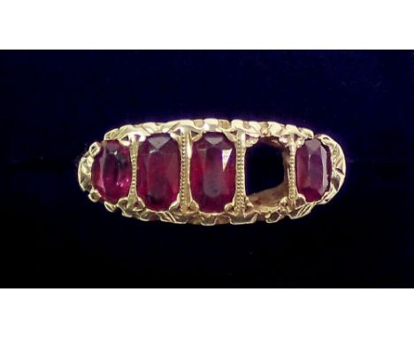 An 18 carat gold ruby ring - one stone deficient, unmarked, size M, largest ruby 6 x 3mm, 4.6g