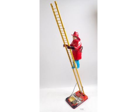 A Mar Toys metal climbing fireman on ladder, clockwork toy, 58cm tall
