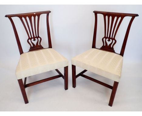 A pair of Georgian Chippendale style mahogany dining chairs with vase form splat and scroll over top rail, upholstered in cre