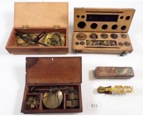 A box of gold scales and weights, a boxed set of scales and a boxed set of weights plus a sovereign scale boxed