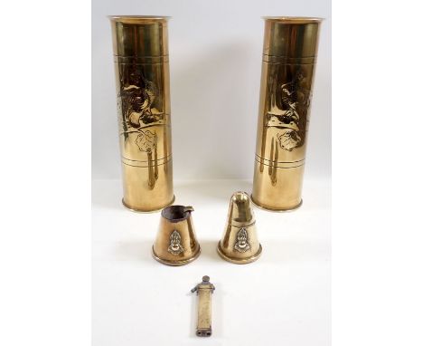 A pair of brass Trench Art vases embossed birds and a Trench Art lighter, ashtray and another lighter