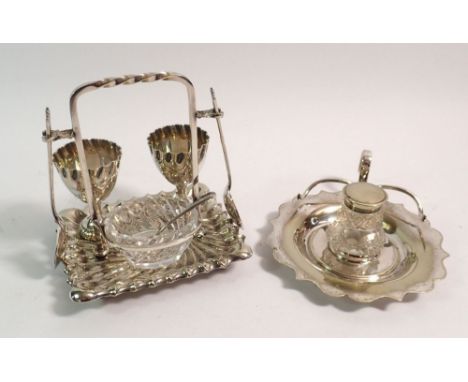 An Edwardian silver plated eggcup stand for two with cut glass salt and silver plated and cut glass inkwell 