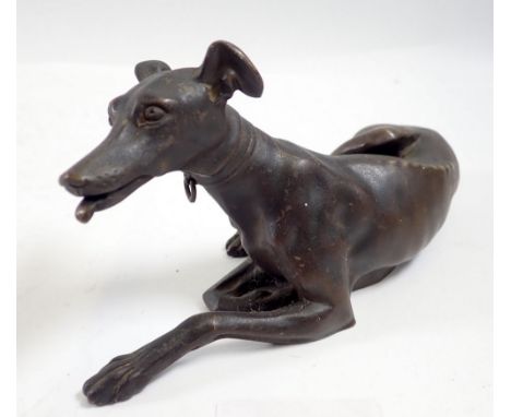 A bronze reclining greyhound, 15cm wide