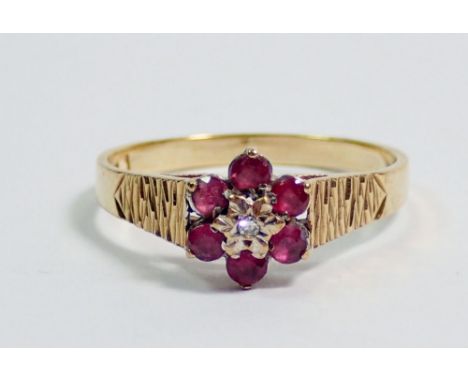 A 9 carat gold ruby and diamond cluster ring, size K, 2.1g