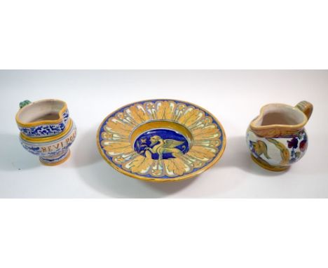 An Italian Maiolica dish painted griffin, 24cm diameter and two Maiolica jugs