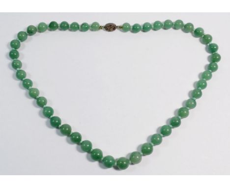 A string of jade beads with silver clasp 