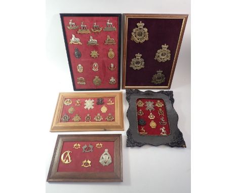 Five framed displays of military cap badges and helmet plates, total forty nine including cyclists corps, Lincolnshire, Notts