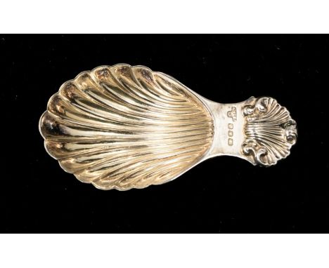 A Georgian style silver caddy spoon, shell shaped bowl and rocaille handle terminal, hallmarked A Chick &amp; Sons., London, 