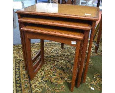A nest of three teak tables, inset with glass tops; with G-plan tile top coffee table (2)