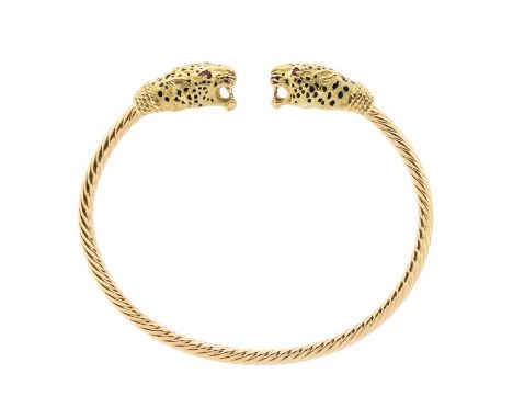 A French 18ct gold and enamel leopard bangle, comprising a rope twist sprung bangle with leopard head terminals, the eyes set