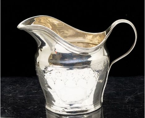 **REOFFER JANUARY A&C £30-40** A George III silver helmet shaped cream jug, bright-cut engraved band of lambrequin decoration