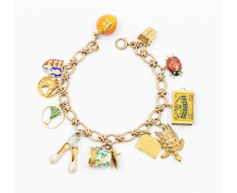 A 9ct gold charm bracelet with various charms including enamel apple opening to reveal Adam & Eve, Queen of hearts playing ca