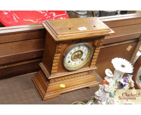 An Edwardian light oak mantel clock with eight day striking movement 
